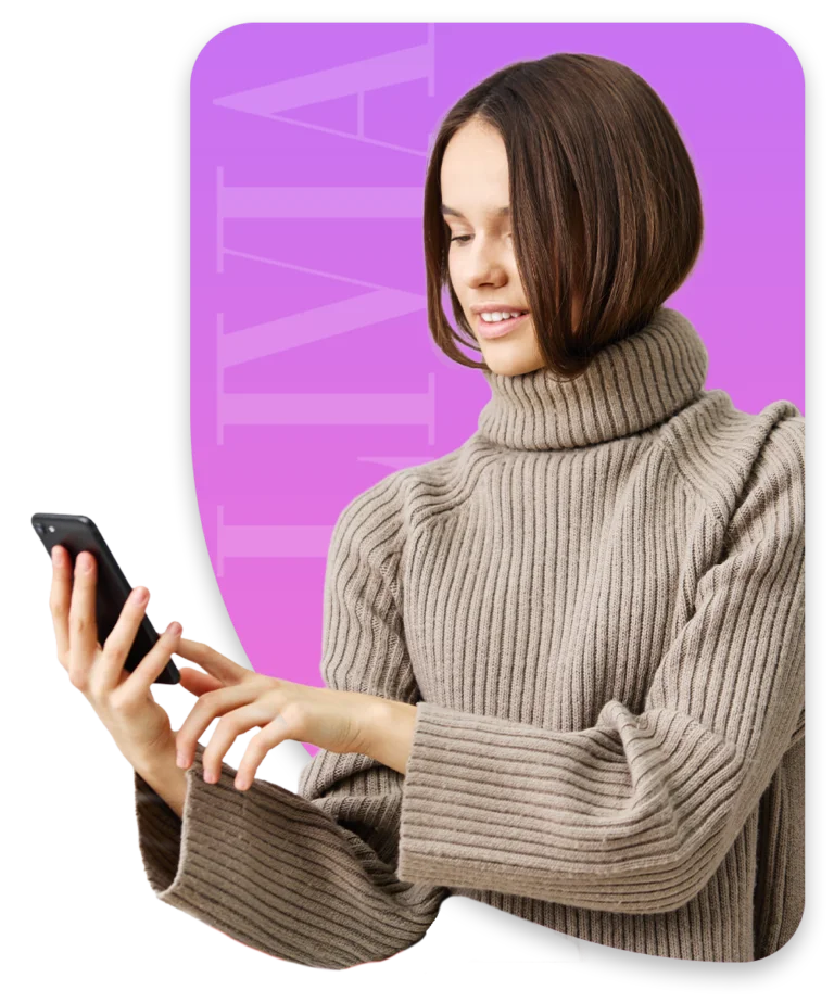 Woman smiling at her phone against a colorful LIVIA backdrop