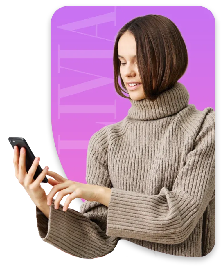 Woman smiling at her phone against a colorful LIVIA backdrop