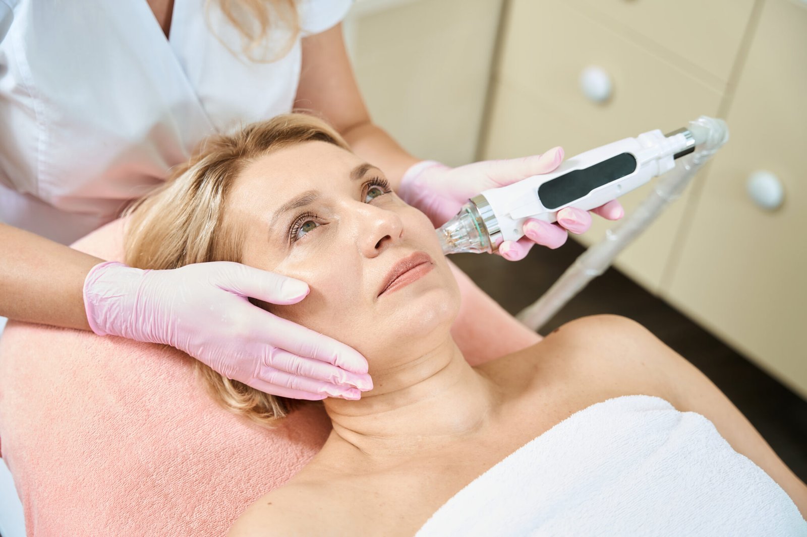 woman having secret rf microneedling done on her face