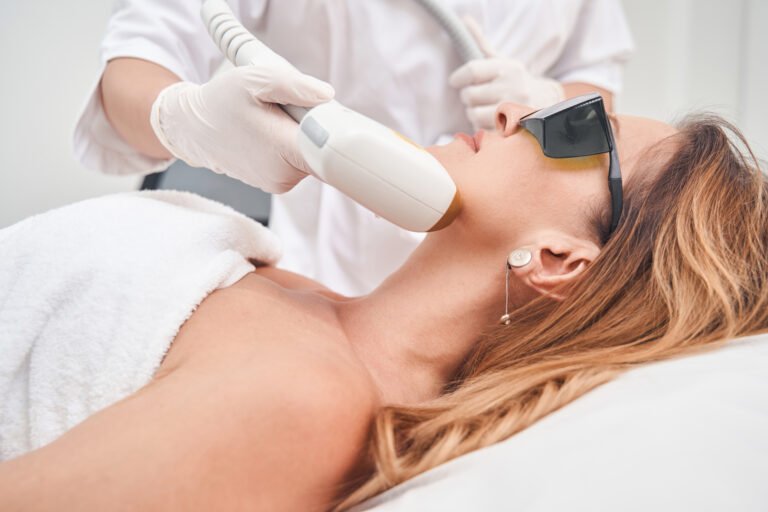 Attractive female removing hair in beauty salon