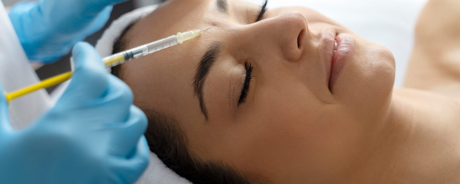 Cosmetologist does prp therapy on the face of a beautiful woman in a beauty salon. Cosmetology and skin treatment concept